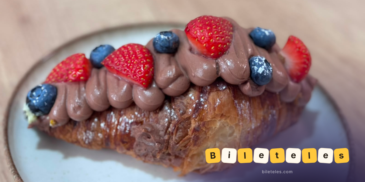 Croissant with chocolate, strawberries, and blueberries
