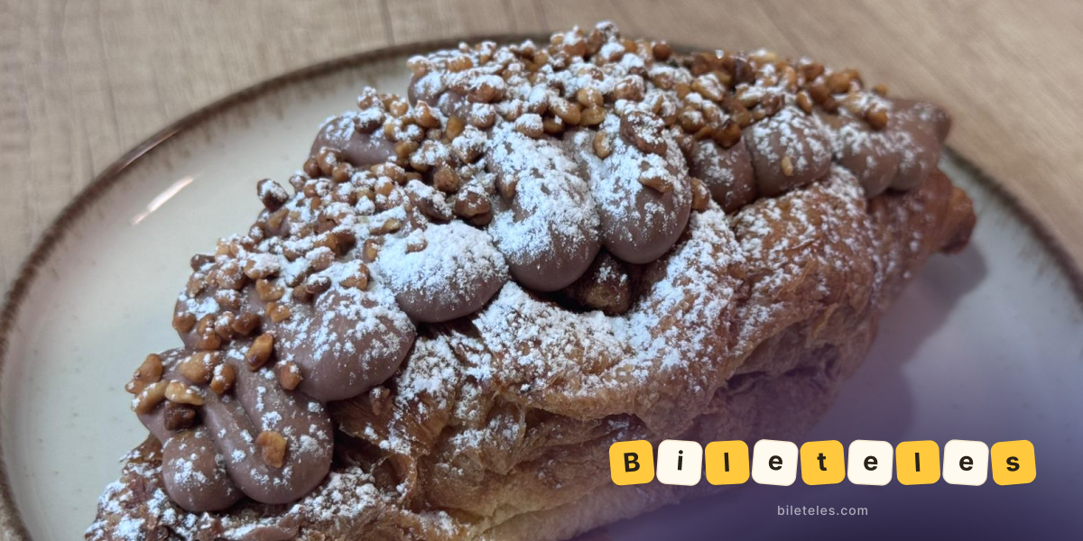 Croissant with chocolate cream, hazelnuts, and powdered sugar