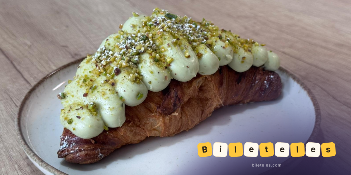 Croissant with pistachio cream, chopped pistachios, and powdered sugar