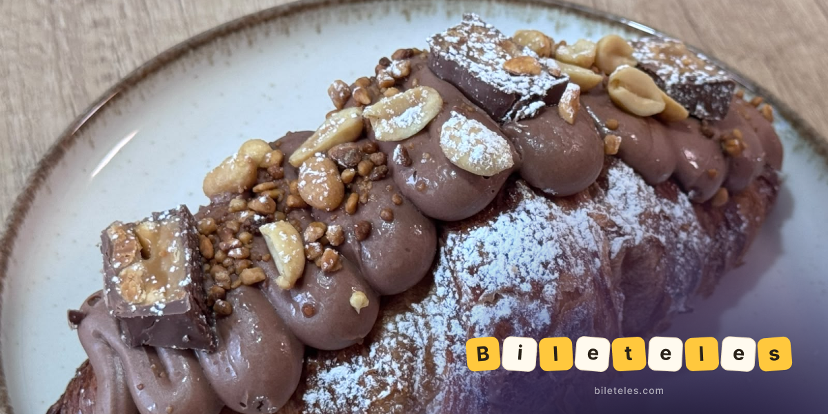 Croissant with chocolate, peanuts, and Snickers pieces